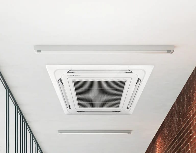 Recessed ceiling-mounted cassette air conditioning unit fitted in a commercial space
