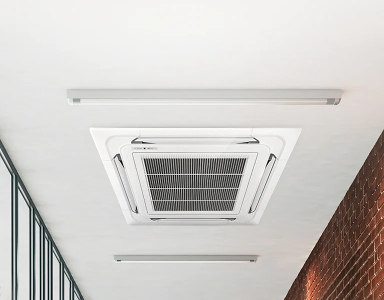 Recessed ceiling-mounted cassette air conditioning unit fitted in a commercial space